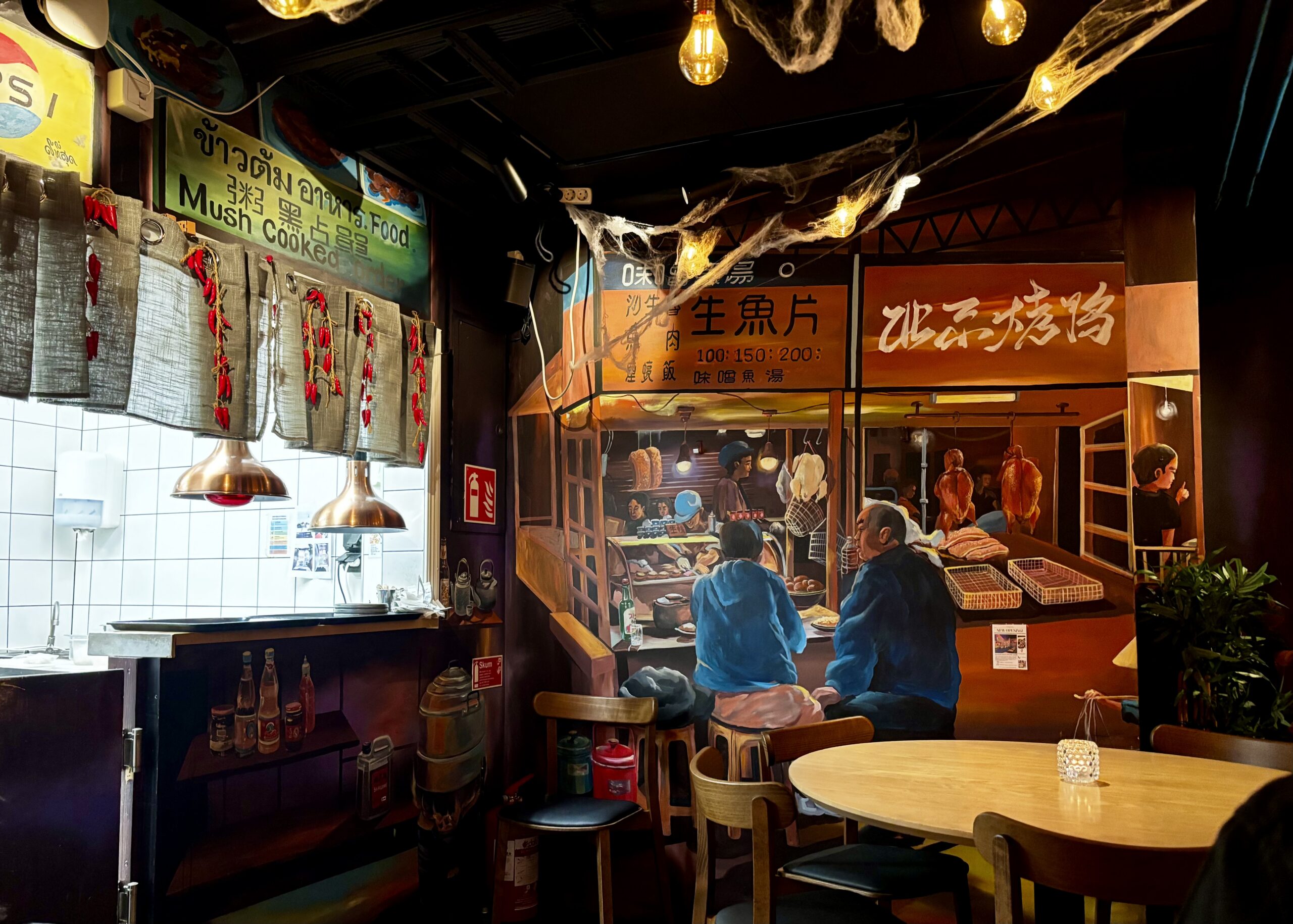 image shows the back area of Ho's Tapas in Stockholm with wall art.