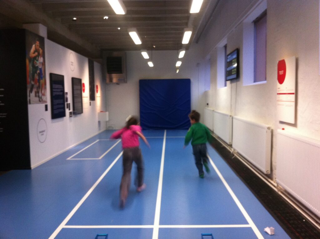 image shows two kids racing at the riksidrottsmuseum in stockholm